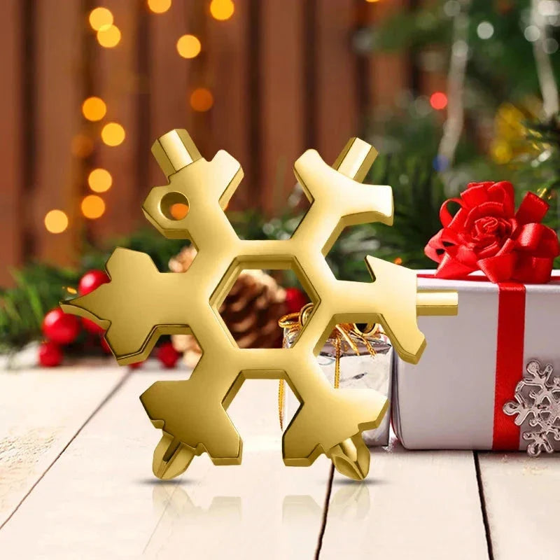 Gold snowflake multitool with Christmas gift box, festive holiday lights and pine decor