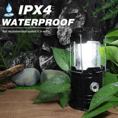 Lit black camping lantern with water droplets on it, surrounded by wet green leaves, text reads IPX4 WATERPROOF and Not recommended soaked it in water