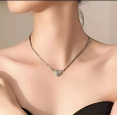 Magnetic Love Patchwork Necklace - Silver-toned multi-strand choker necklace with a pave-set small heart pendant, worn on a person's neck.