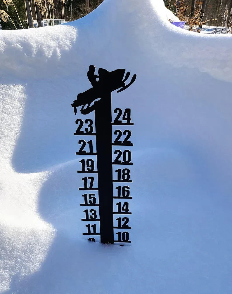 Snow Reader - Snowmobile rider silhouette top snow gauge installed in deep snow, with lower measurement markings covered by accumulated snow