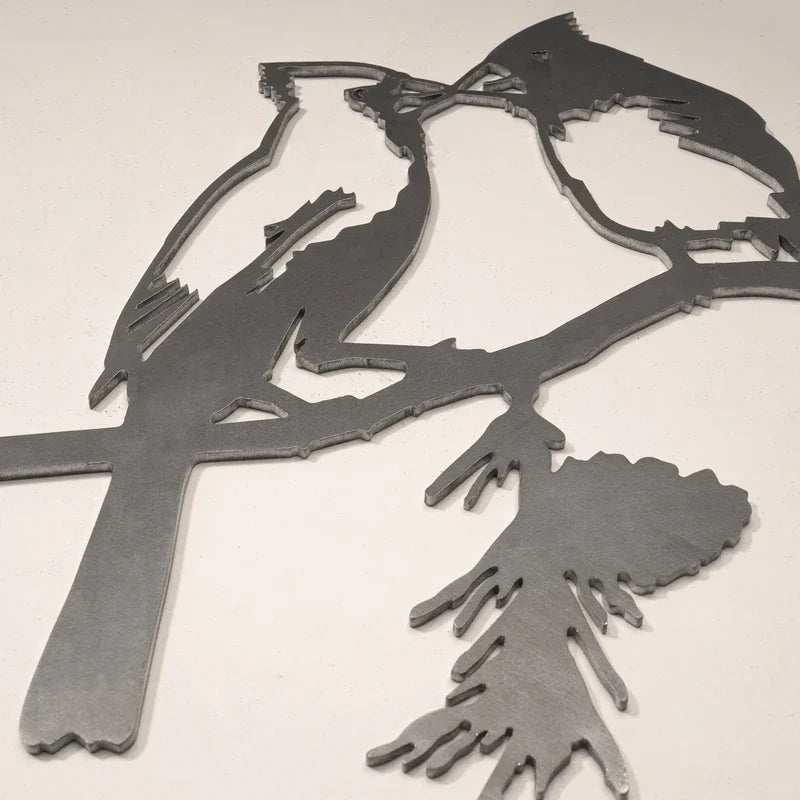 Garden Decor - Close-up of raw unweathered laser-cut steel kissing cardinal decor showing cut edge detail on a plain light surface
