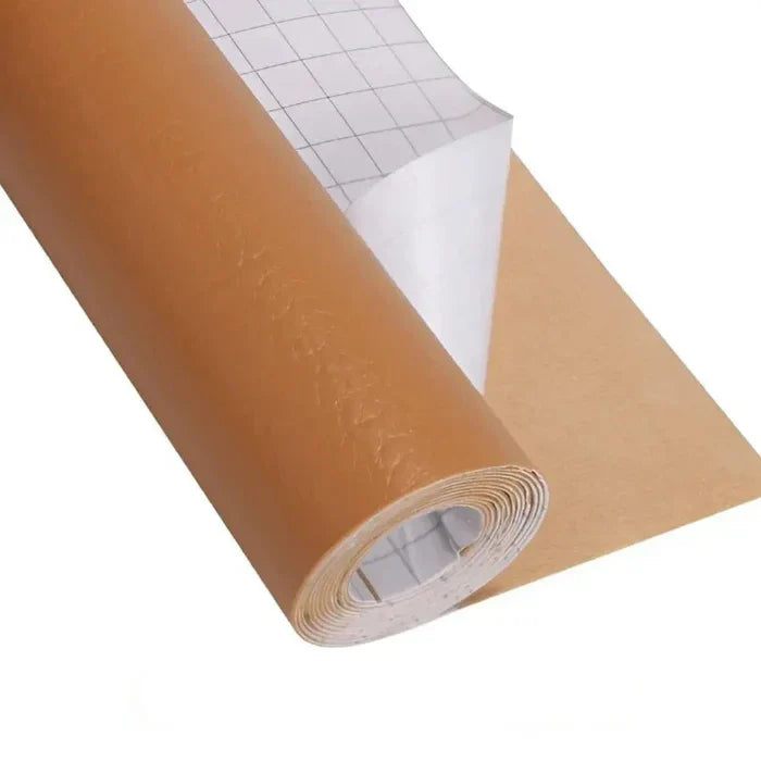 Roll of tan brown leather repair kit material with grid-lined release paper partially peeled back