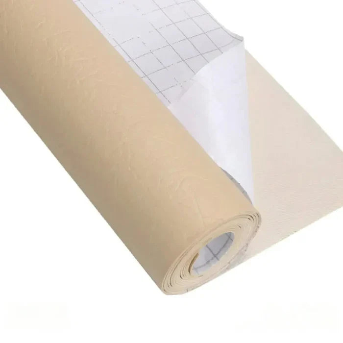 Roll of beige leather repair kit material with grid-backed release paper partially peeled