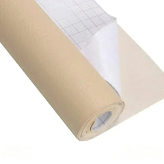 Roll of beige leather repair kit material with grid-backed release paper partially peeled