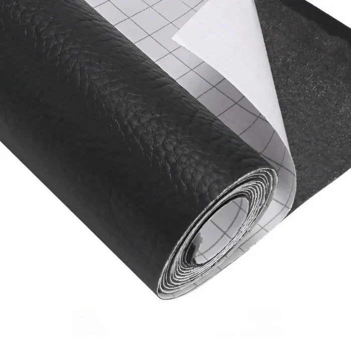 Roll of black textured leather repair kit material with grid-backed white release paper partially peeled