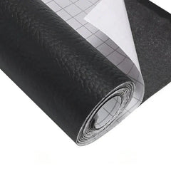 Roll of black textured leather repair kit material with grid-backed white release paper partially peeled