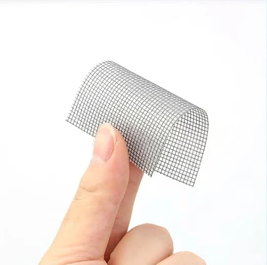Fingers holding a small curved piece of mesh window screen repair tape
