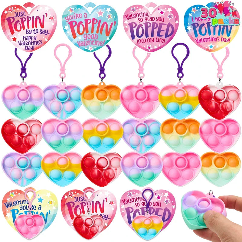 Heart-shaped pop fidget keychains and matching heart greeting cards; valentines day cards with pop fidget keychains are shown.