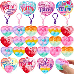 Heart-shaped pop fidget keychains and matching heart greeting cards; valentines day cards with pop fidget keychains are shown.