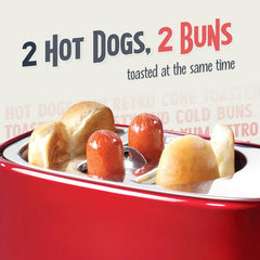 Close-up of a retro hot dog toaster’s top slots holding two cooked hot dogs and two hot dog buns.