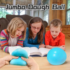 Giant Stress Ball - Hands squeeze a blue dough ball in plastic, with a round blue dough ball nearby and three children watching from behind.