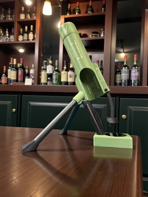 Close-up of the mortar-shaped bottle opener resting on a wooden surface, with liquor shelves in the background