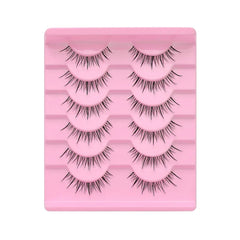 Bottom Lash - Pink tray holding six pairs of false eyelashes with a spiky, natural wispy design arranged in two columns.