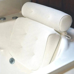 White textured bath pillow positioned against the curved back of a white bathtub