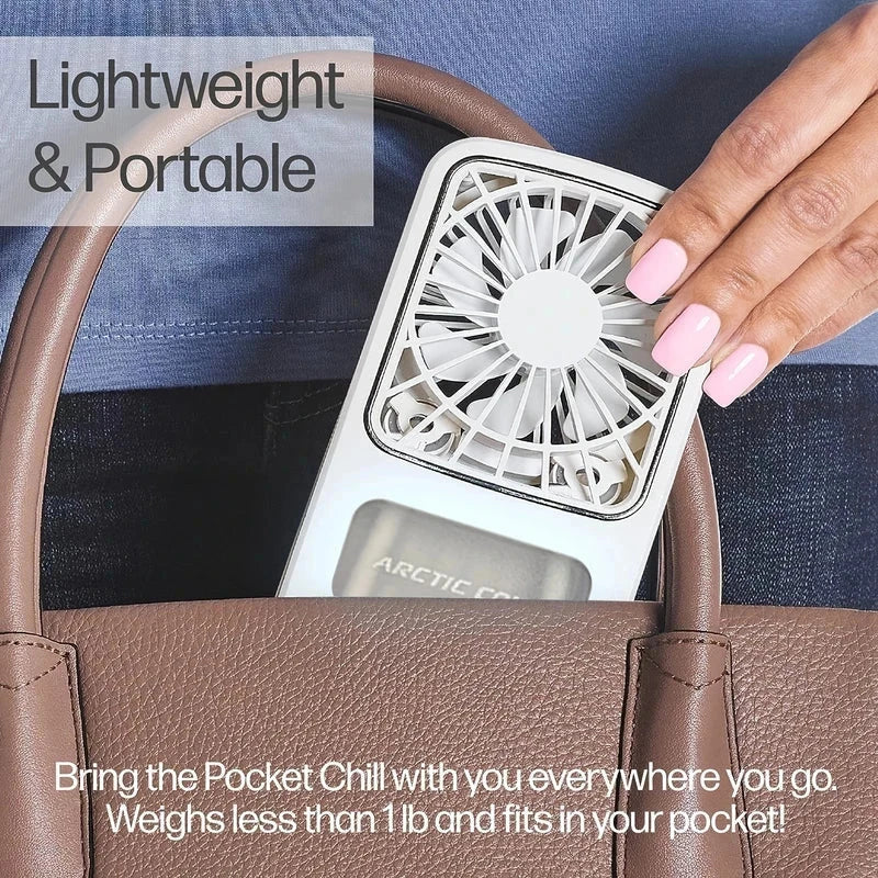 Hand lifting a white portable fan out of a brown handbag, showing its compact size