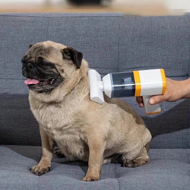 Car Vacuum Cleaner - Hand holding a small handheld vacuum against a sitting pug dog on a gray fabric couch