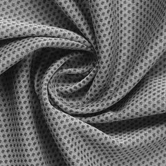 Close-up of twisted black and white textured cooling towel fabric with a repeating dot pattern.