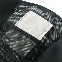 Knee Massager With Heat - Close-up of a white fabric insert in the mesh pocket of a black brace