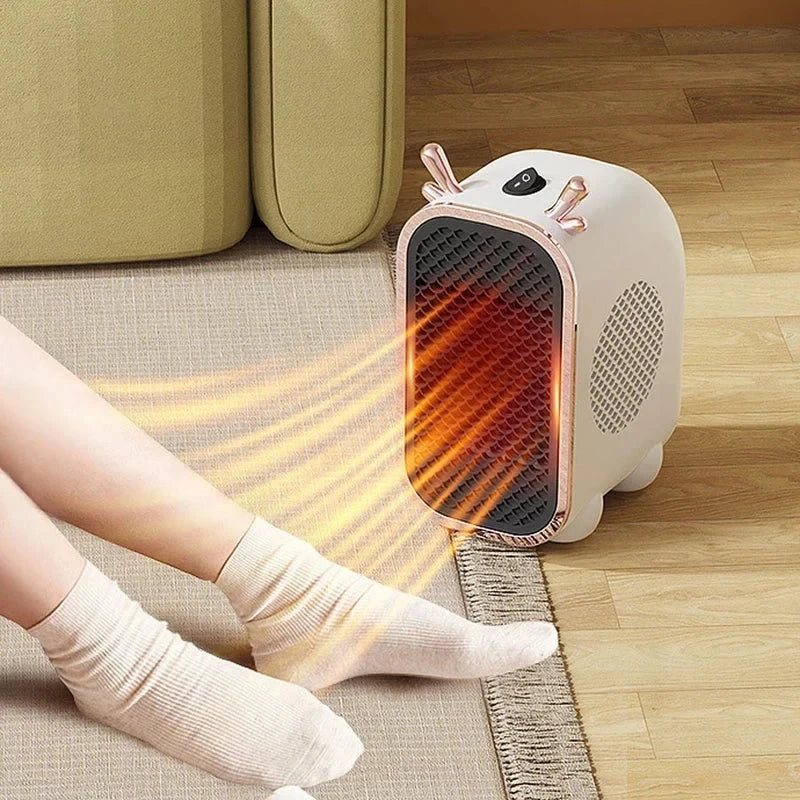 Mini Space Heater - White portable heater running near a person's socked feet on a rug, blowing warm heated air toward the legs