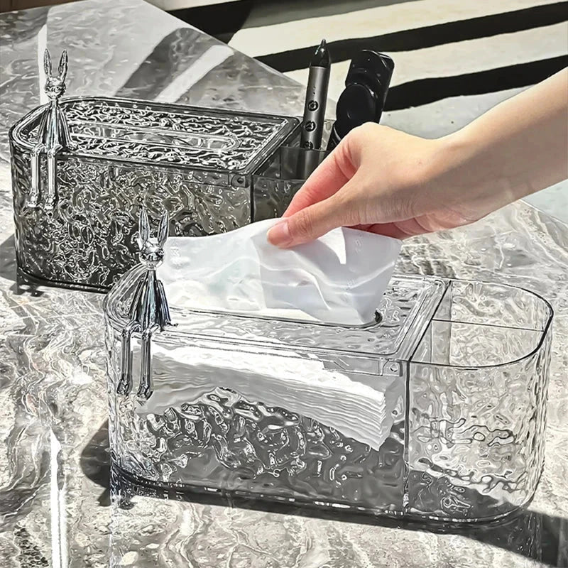 Tissue Box Holder - Two clear textured tissue boxes with rabbit figurines, one in front with a hand pulling out a white tissue