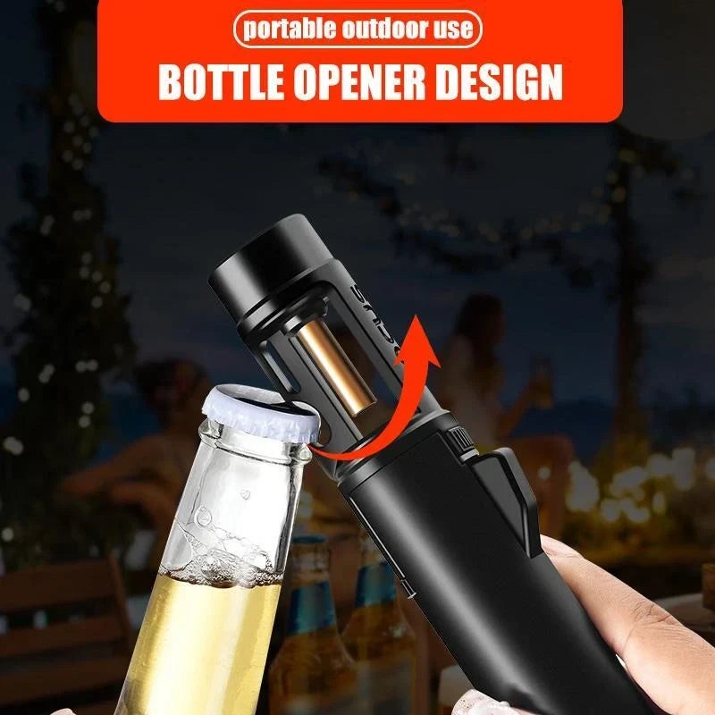 Hand holds black butane torch lighter hooked under beer bottle cap with red arrow showing bottle opener use, outdoor night background