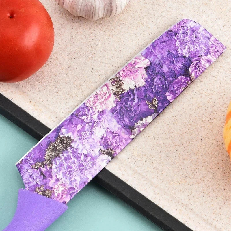 Purple floral chef knife on a cutting board with tomato and garlic, part of a 6 piece kitchen utensil set