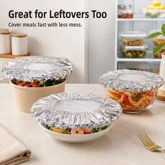 Three food containers with leftovers on a counter, each sealed with microwavable dish covers, near a fridge.