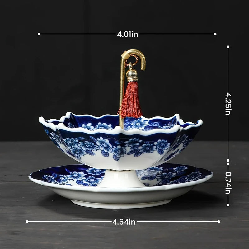Size dimensions shown for a blue and white umbrella-style ceramic tea filter with red tassel and matching base