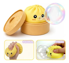 Sensory Bubble - Yellow steamed bun squish toy in a small steamer blows a clear bubble, with two inset panels showing squeezing and pressing the toy.
