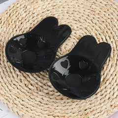 Nipple Concealers - Close-up of a pair of black rabbit-ear shaped nipple covers, showing the adhesive inner side with heart-shaped cutouts