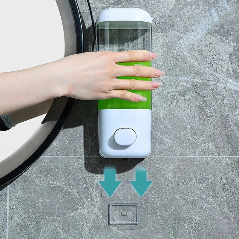 Hand pressing travel set bottles wall-mounted soap dispenser; adhesive mount shown below on gray tile