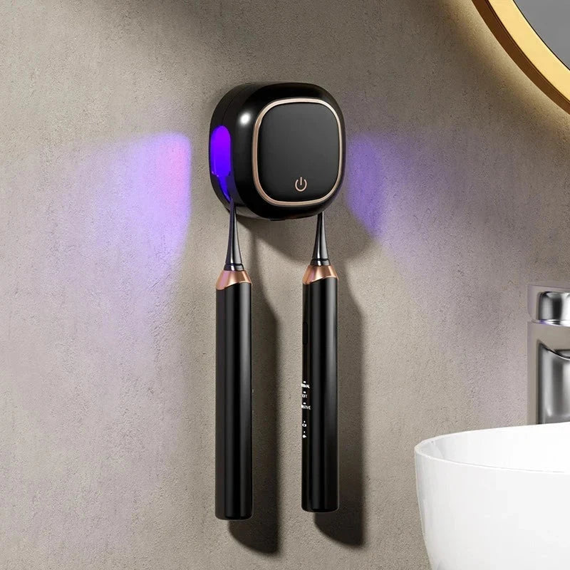 Uv Toothbrush Sanitizer Holder - A wall-mounted toothbrush holder holds two black electric toothbrushes, purple UV light active, no hand present