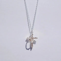 Faith Necklace - Silver-tone crystal-embellished cross pendant on silver chain, hanging against a plain light background