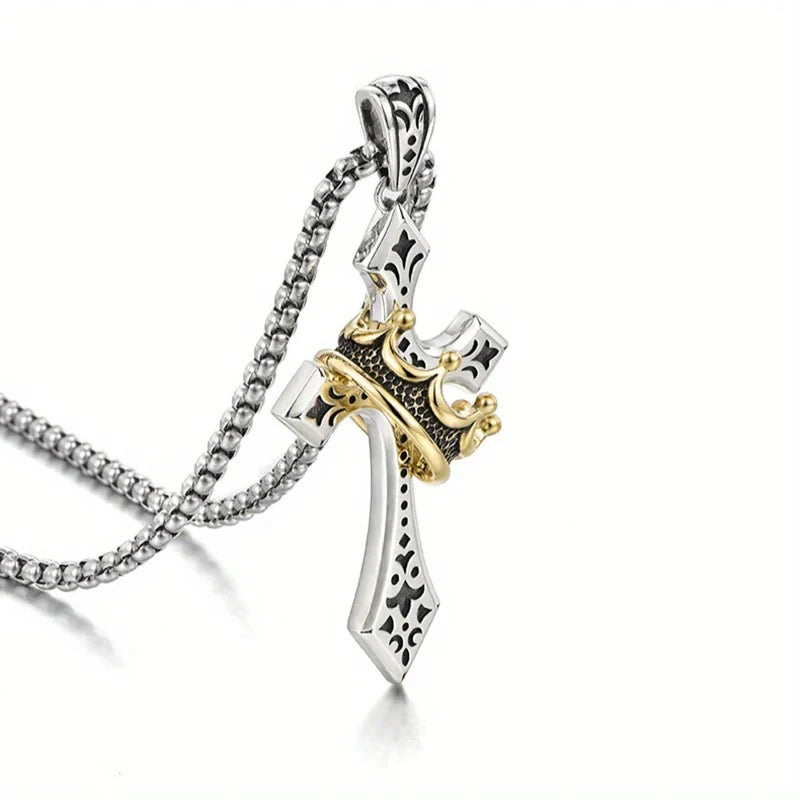 Crown Pendant - Two-tone cross pendant with crown, shown at an angle attached to a box chain, on a white background.