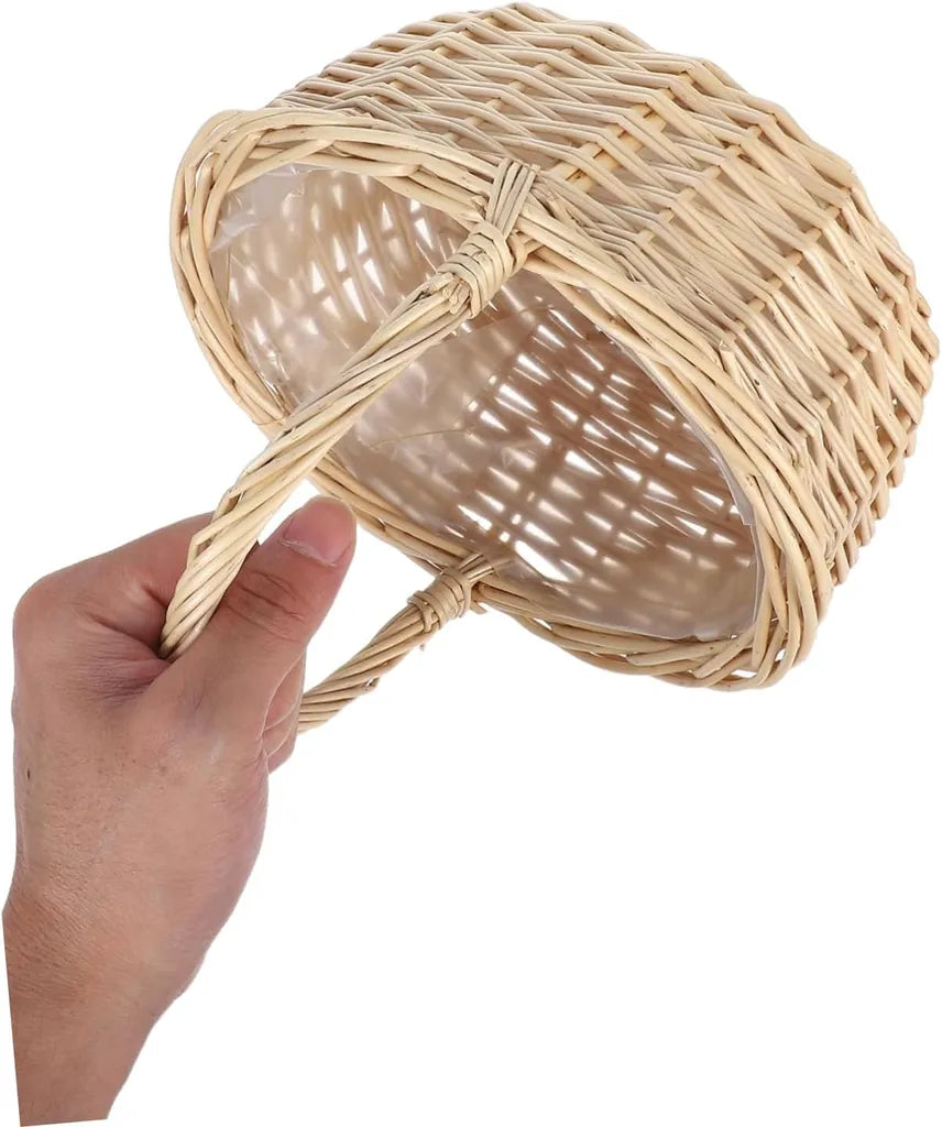 Hand holding natural woven rattan basket with integrated handle and liner