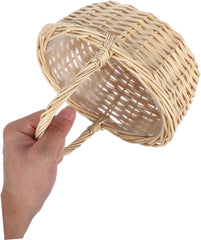 Hand holding natural woven rattan basket with integrated handle and liner