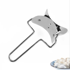 Stainless steel dumpling maker with cooked dumplings on plate