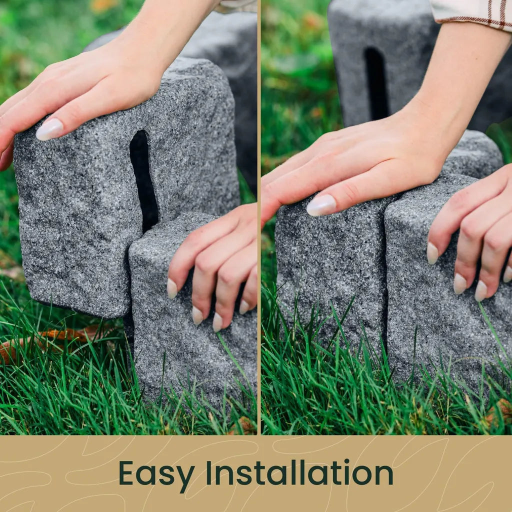Close-up of hands connecting interlocking grey stone landscape edging pieces