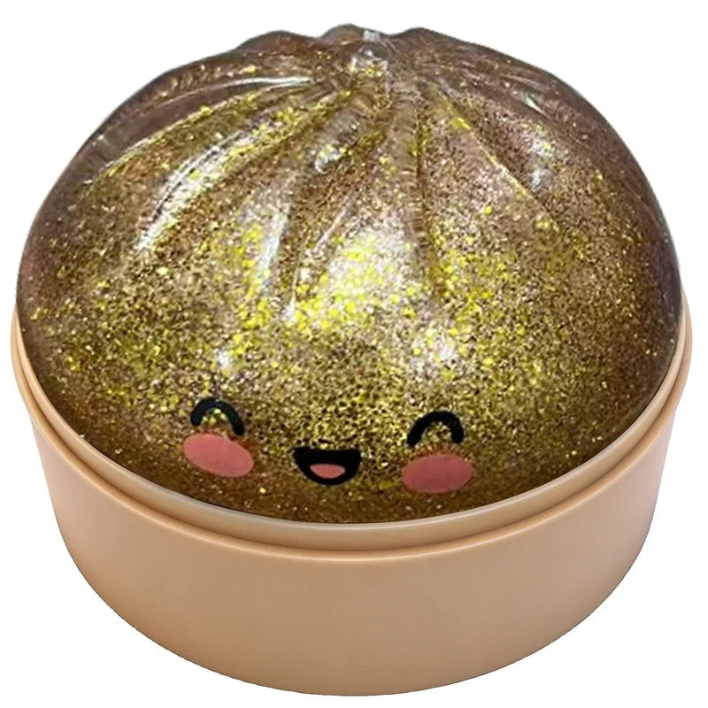 Smiling gold glitter squishy dumpling toy placed in its mini steamer box